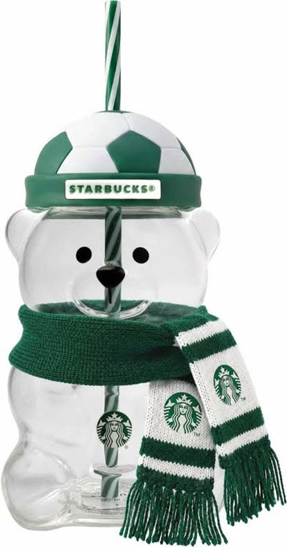 Clear Starbucks bear shaped glass cup with green soccer ball lid and striped straw