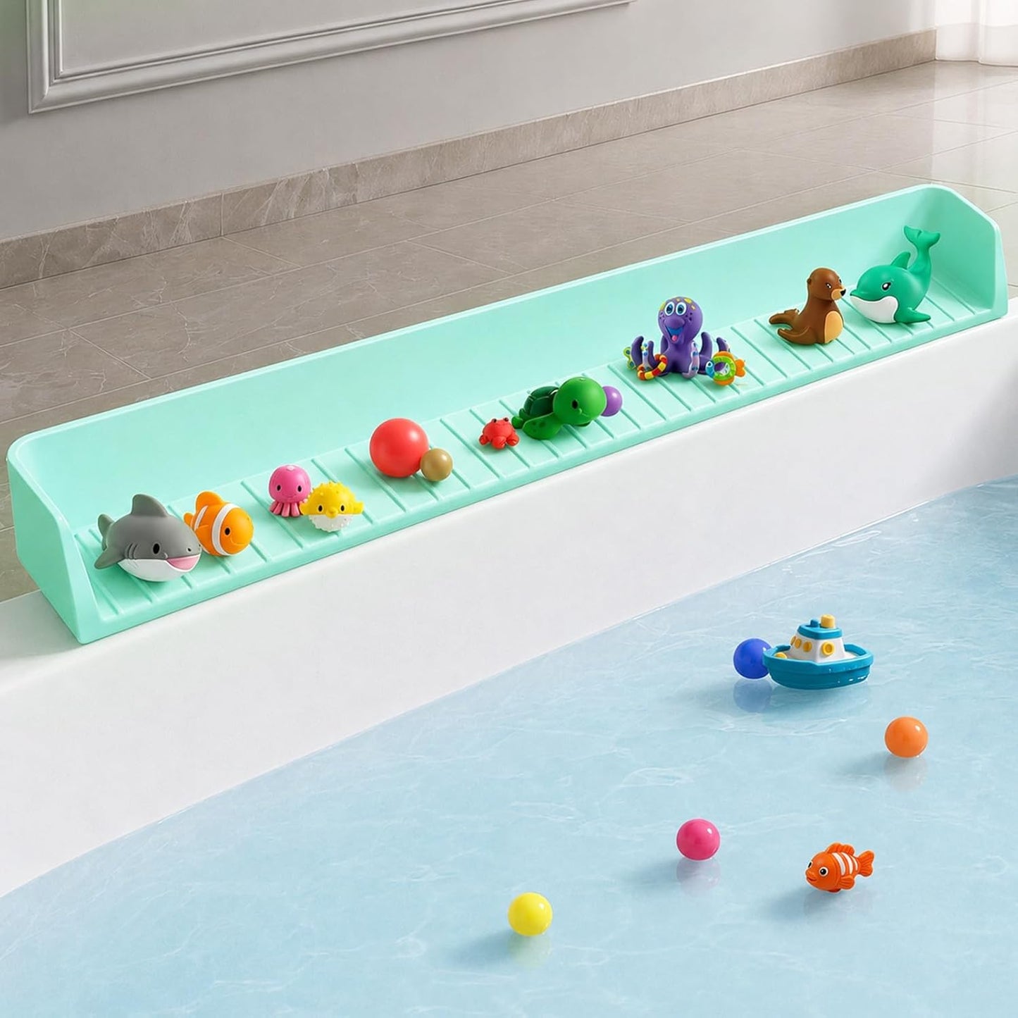 Green kids bathtub splash guard with suction cups holding bath toys on the tub edge