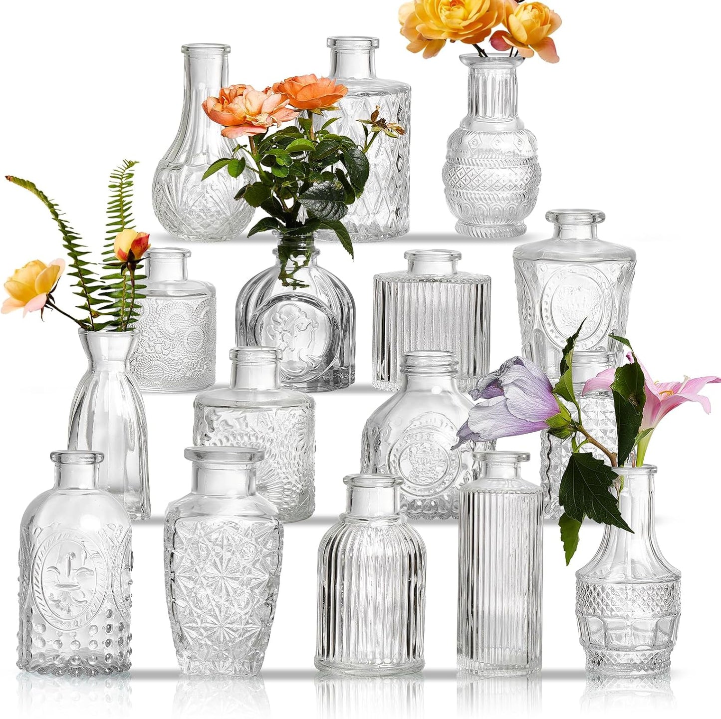 Set of 16 assorted clear glass bud vases arranged as wedding table centerpieces