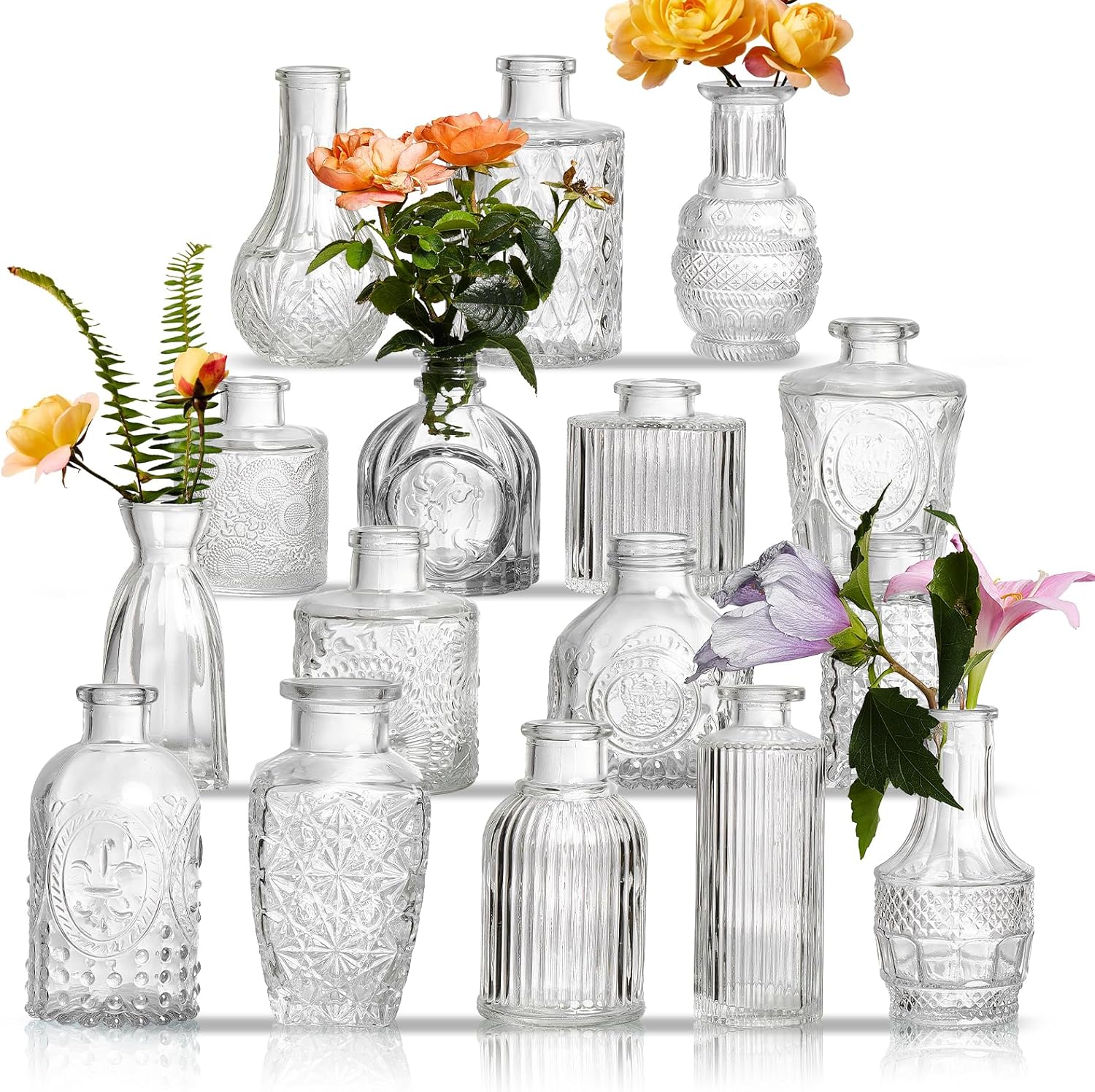 Set of 16 assorted clear glass bud vases arranged as wedding table centerpieces