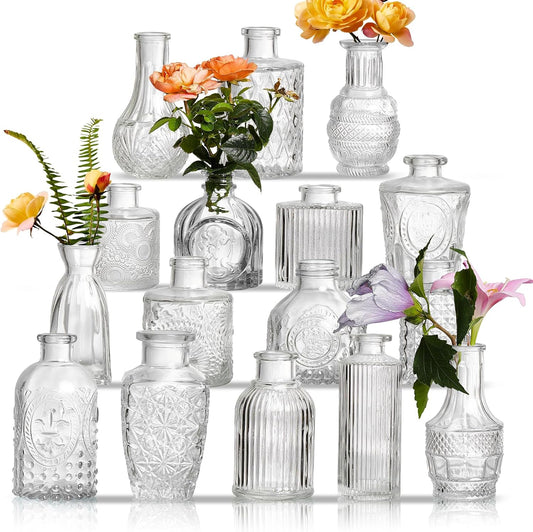 Set of 16 assorted clear glass bud vases arranged as wedding table centerpieces