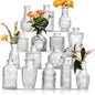 Set of 16 assorted clear glass bud vases arranged as wedding table centerpieces