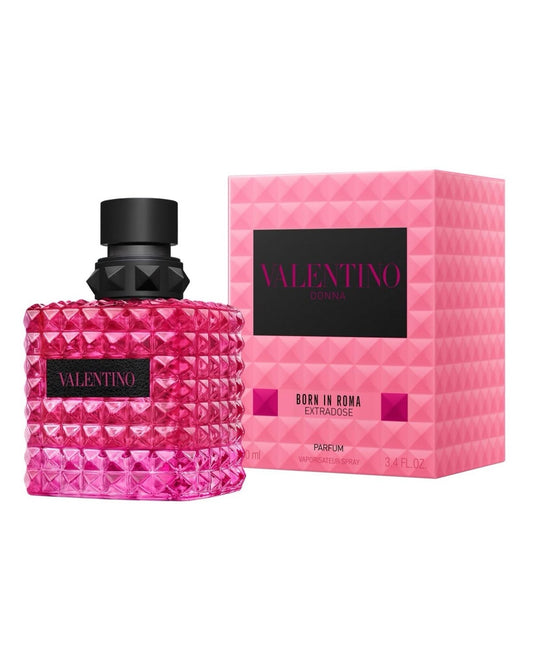 Valentino Born in Roma Extravagante perfume bottle in a textured pink rhinestone-like finish with a black cap, shown next to its pink geometric box packaging.